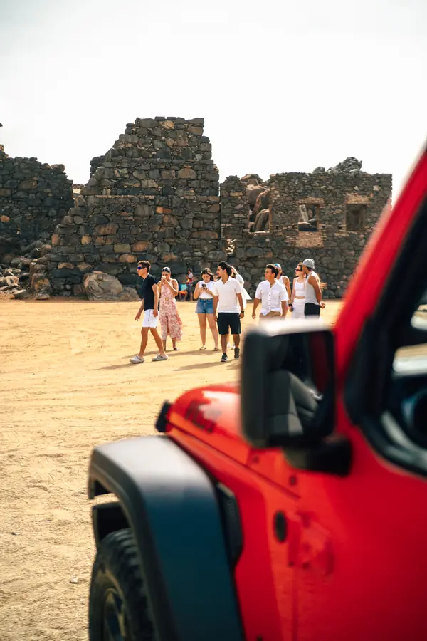 Amigos en las ruinas del molino de oro de Bushiribana junto a un Jeep de EFE